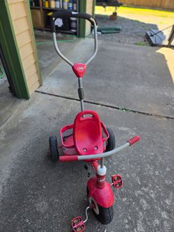 Red Flyer pushing tricycle