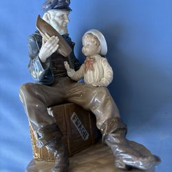 Lladro Man and boy holding toy boat
