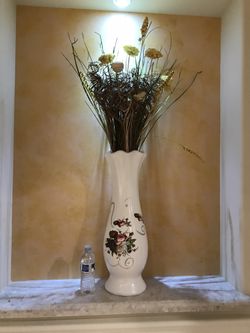 Ceramic vase with fake flowers arrangement