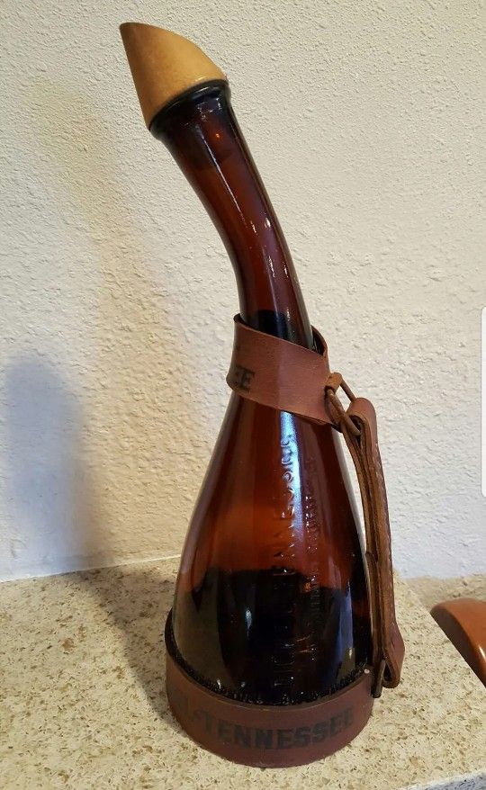 Empty Dickel tennessee whiskey vintage bottle with leather