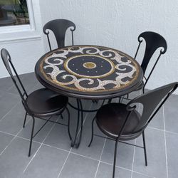 Beautiful vintage 38" wrought iron bistro table set with 4 chairs. Unique with mosiac tile design. Perfect for indoors or outside. Comes with brand ne