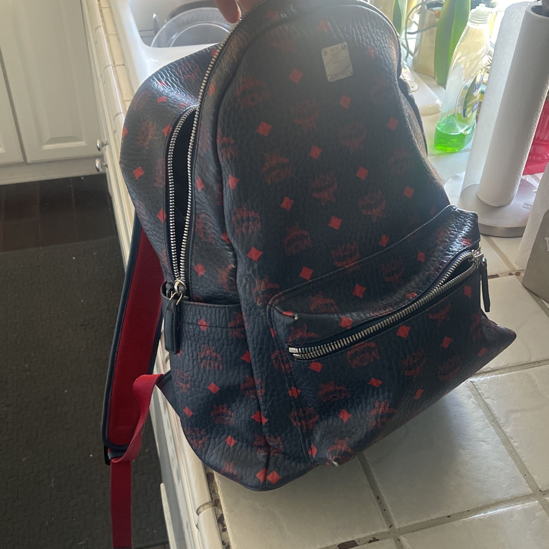 fairly new mcm backpack navy blue with red logo