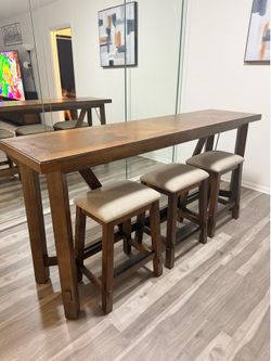 Console table set with three chairs.