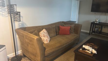 Two large couches and tv stand and table