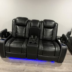 Power reclining sofa with adjustable power headrests. It has a fabulously modern look with midnight-colored polyester upholstery, cross hash stitching