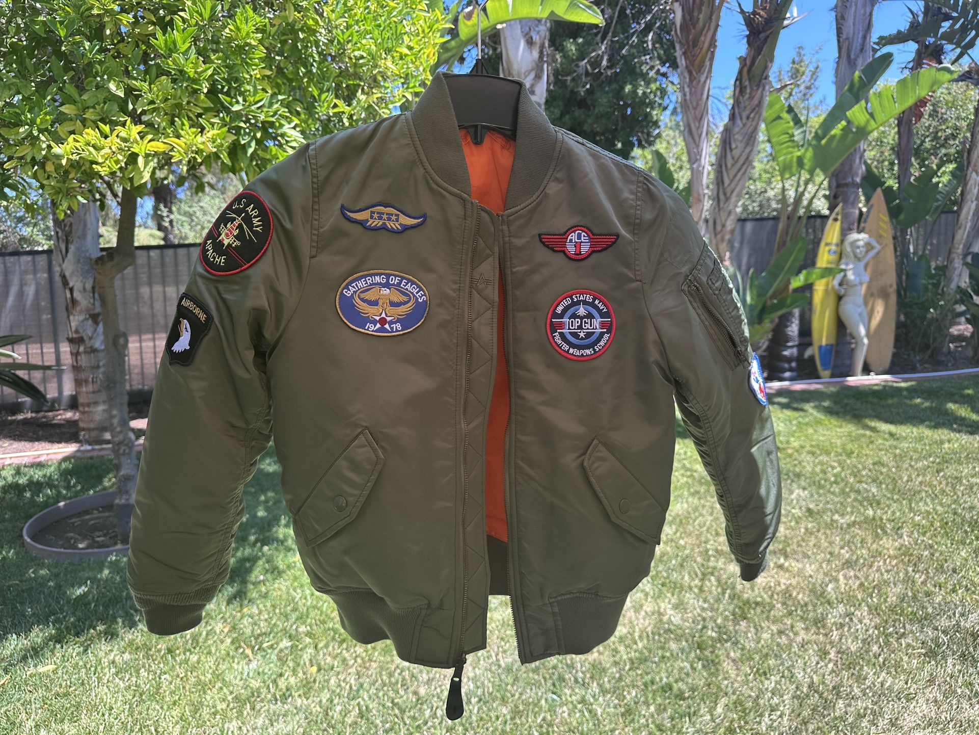 Alpha Industries Youth MA-1 Bomber Jacket with Patches. This kids' flight jacket is based on the classic MA-1 men's bomber jacket.