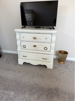 White antique dresser with gold hardware