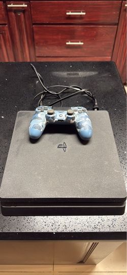 PlayStation 4 with controller and cable