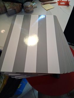Pottery Barn Kids Gray & White Striped Cork-Backed Placemats
Rectangular placemats featuring wide gray and white stripes, a glossy wipe-clean surface,