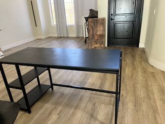 Black desk, sturdy, partially disassembled for transport.