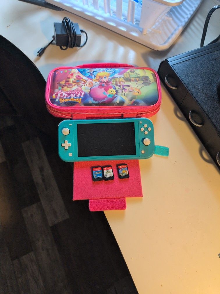 Nitendo Switch Lite With 3 Games And 2 Games Download. With Charger And Case
