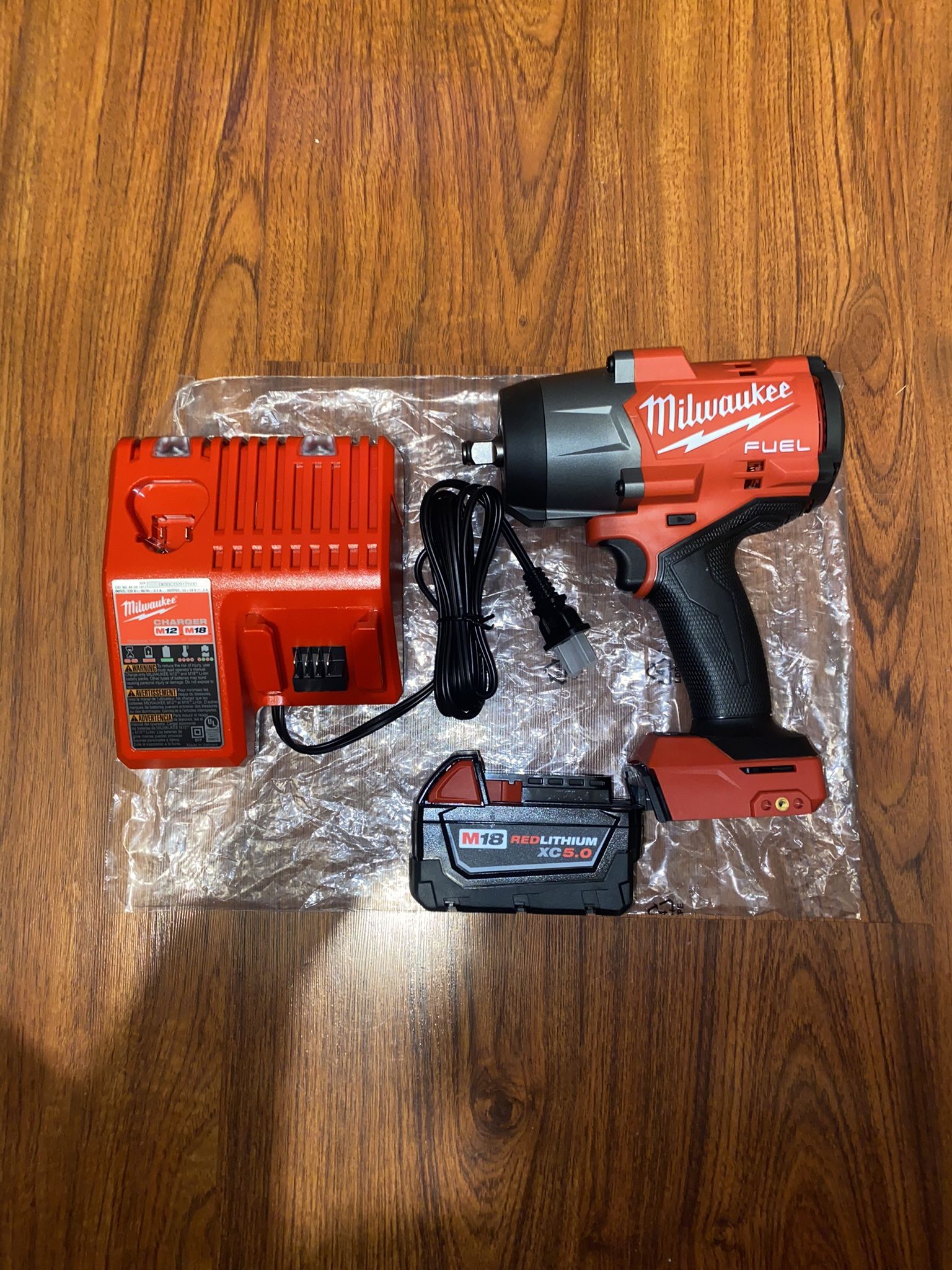 New Milwaukee M18 Fuel Brushless 1/2” Square Ring Impact Wrench (2967-20) 1,600 ft-lbs nut-busting (1) 5.0AH battery (1)M12/M18 Charger