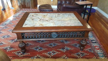 Beautiful antique coffee table w/granite top an encrusted with detailed metal edging.ike new. Only asking 1995