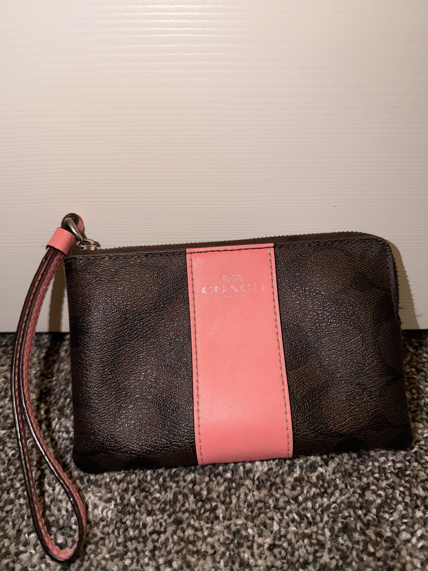 Coach wristlet wallet in brown with a pink