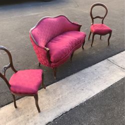 Antique loveseat with two matching era chairs, color magenta. Silk material.