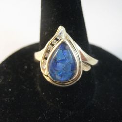 Gold Colored Ring With A Colored Stone And Multiple Clear Stones