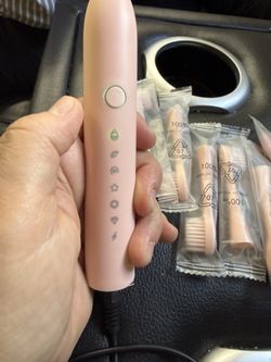 New pink rechargeable tooth brush with 7 heads without box
