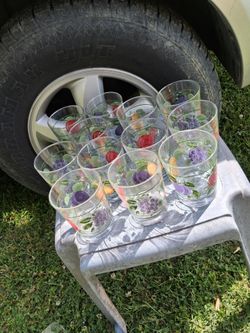 Vintage lot of twelve mid century drinking glasses featuring a vibrant fruit pattern