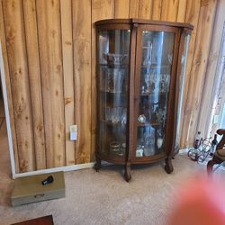 Antique curved glass china cabinet  on wheels.  