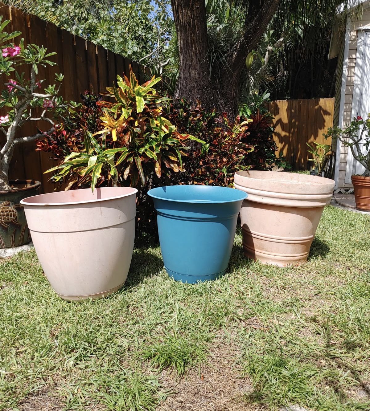Preowned set of three large plastic flower pots