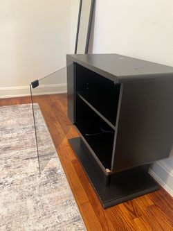 Black media console with a glass door
