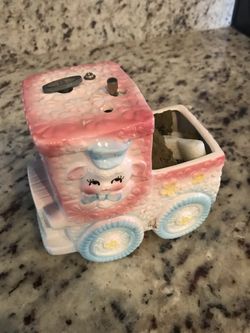 Ceramic flower container for a new baby with a music box in it