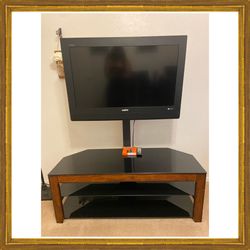 TV WITH  STAND .  32 INCH SANYO TV STAND HAS ADJUSTABLE NECK THAT HOLDS TV AND ROTATES LEFT TO RIGHT. STAND HAS 2 SHELVES.  GREAT FOR GAME ROOM 