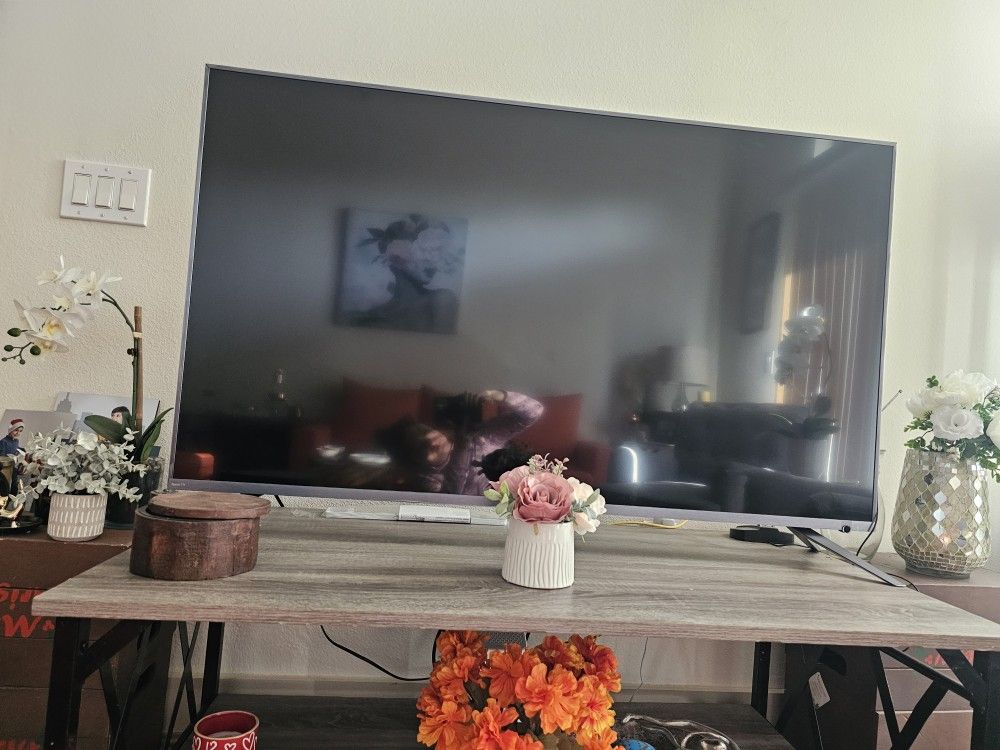 This is an industrial-style gray wood TV stand with open shelving.