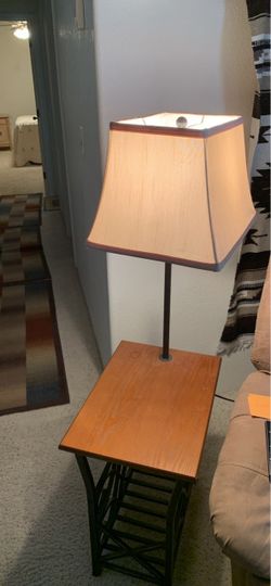 Versatile side table Lamp features a rectangular wood top with a natural grain finish.