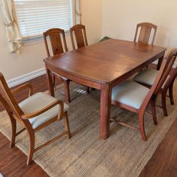 Brown Solid Wood Dining Table With Cushioned Chairs