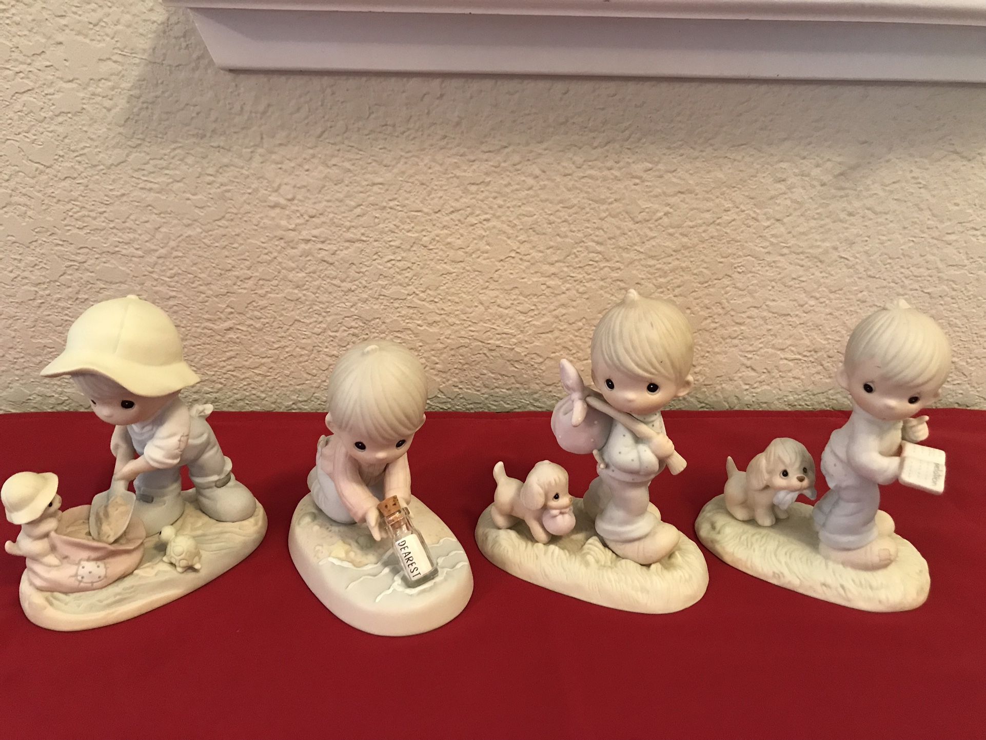 A group of 4 vintage Precious Moments figurines 