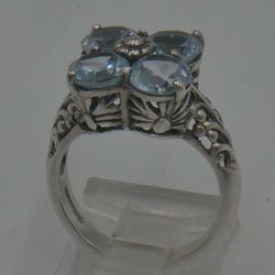 STERLING SILVER 925 RING 4.5 GRAMS SIZE 6 WITH 4 LIGHT BLUE STONES MINT