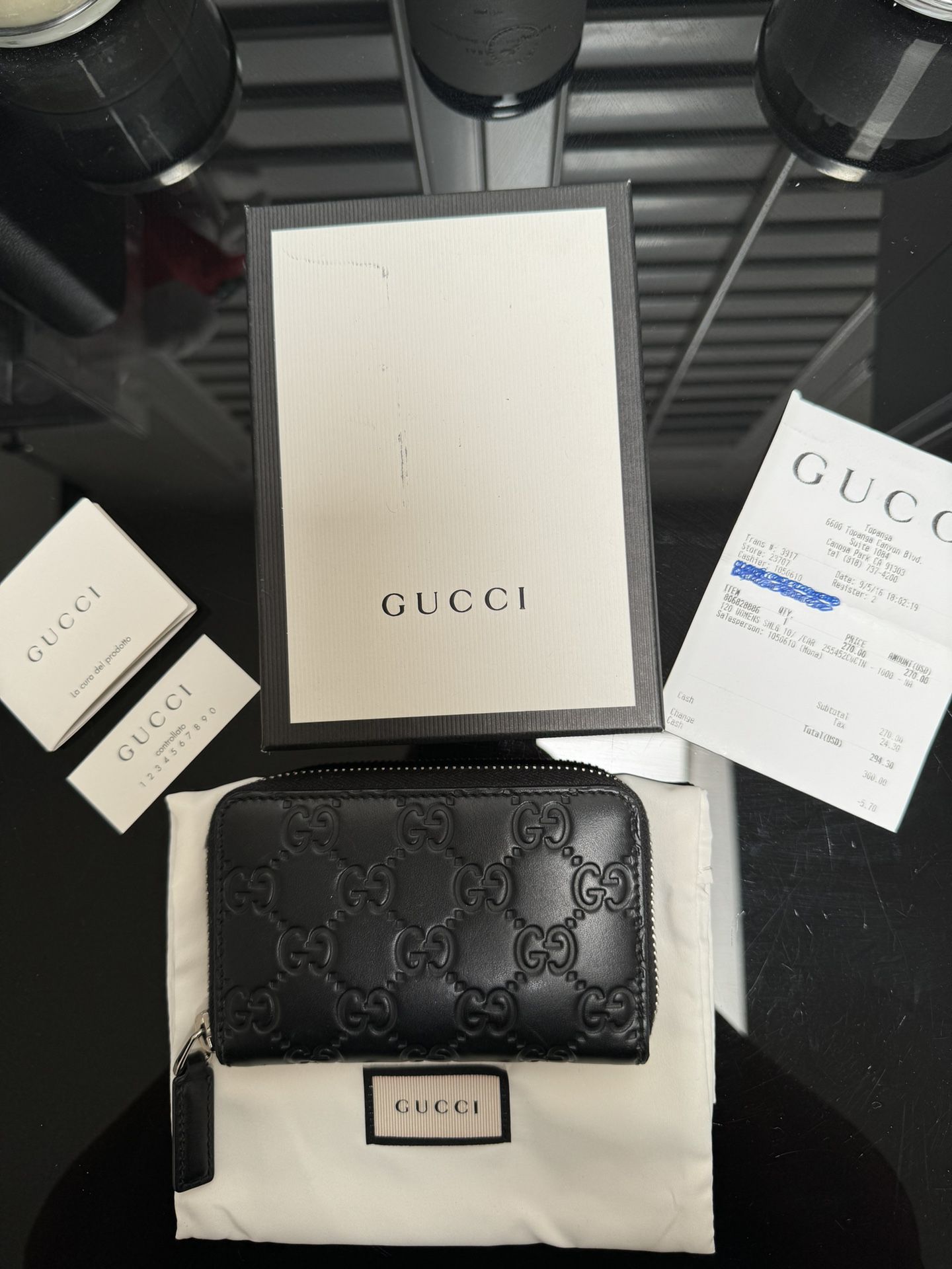 Gucci Leather Monogram Wallet.