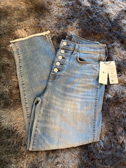 7 For All Mankind jeans feature a high-rise button fly and a frayed hem