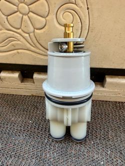 This is a replacement pressure-balance shower valve cartridge compatible with Delta Monitor 13 and 14 series single-handle faucets