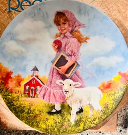 This is a 1985 "Mary Had a Little Lamb" collector plate from the Reco Mother Goose series, featuring artwork by John McClelland