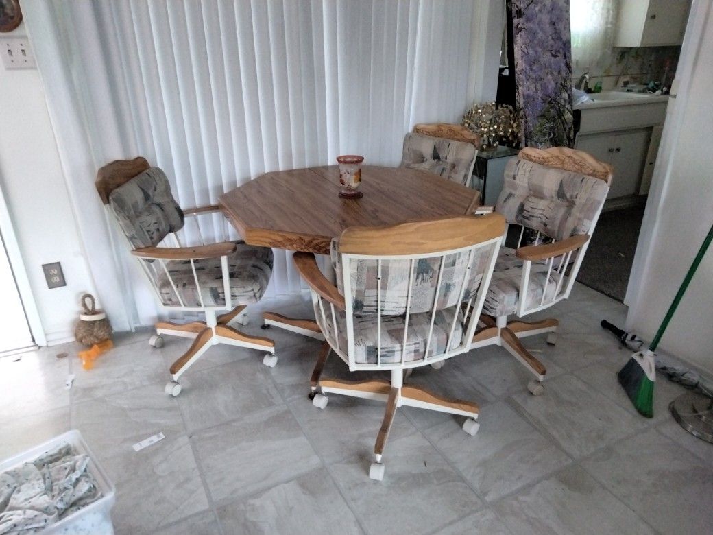Dining Table And Four Rolling Chairs