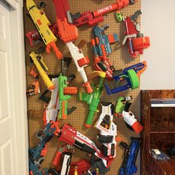 Custom built Nerf wall for 8’ ceiling with 30+ nerf guns, darts & more