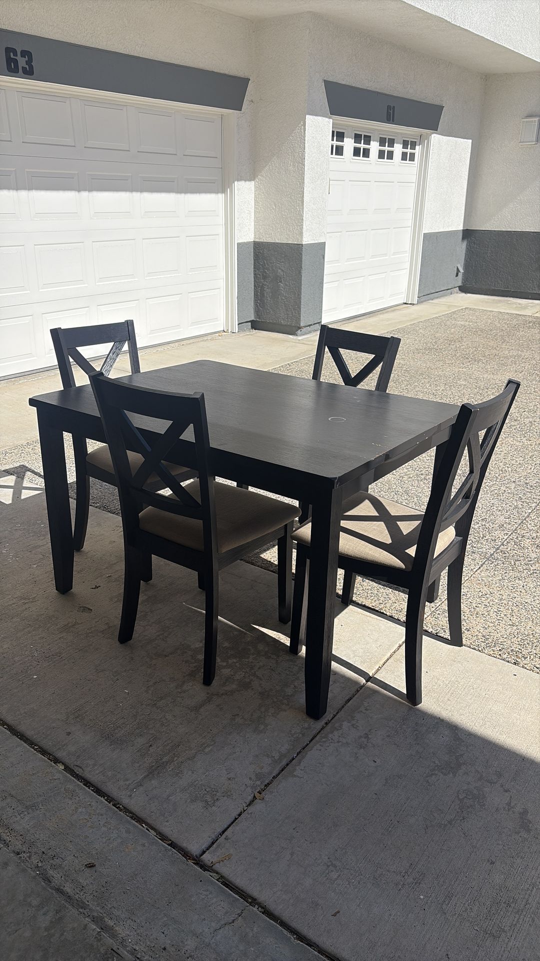 Black dining table with four chairs