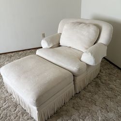 White chair and ottoman with fringe bottom
