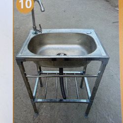 Brand new complete stainless steel sink with stand, faucet, and drain with plumbing