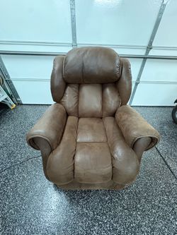 Great condition  plush, brown leather or faux-leather overstuffed  Electric recliner armchair.