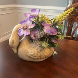 Ceramic swan planter with florals, 10.5x8”. Ceramic planter. Graceful swan with bowed neck in an antiqued finish. Indoor / outdoor planter.