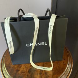 Small brand new Chanel gift bag and ribbon. Ribbon has a flower attached. 