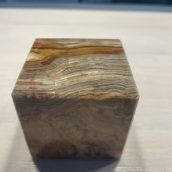polished yellow-banded onyx cube carving.