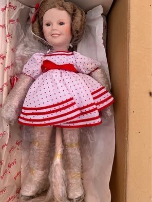 Danbury Mint Shirley Temple porcelain doll, specifically the "Bright Eyes" edition or the "Stand Up and Cheer"