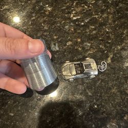 Small Slinkie And Silver Car 
