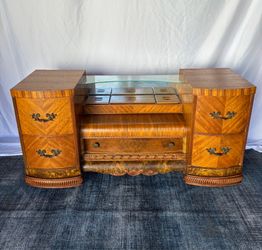 Vintage 1930s Art Deco waterfall vanity with a large carved mirror on casters