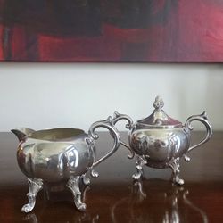 Vintage Sheridan silverplate sugar and creamer set with ornate detailing.