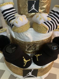 New hand made diaper cake. 4 pair of infant booties. Many styles and themes available.